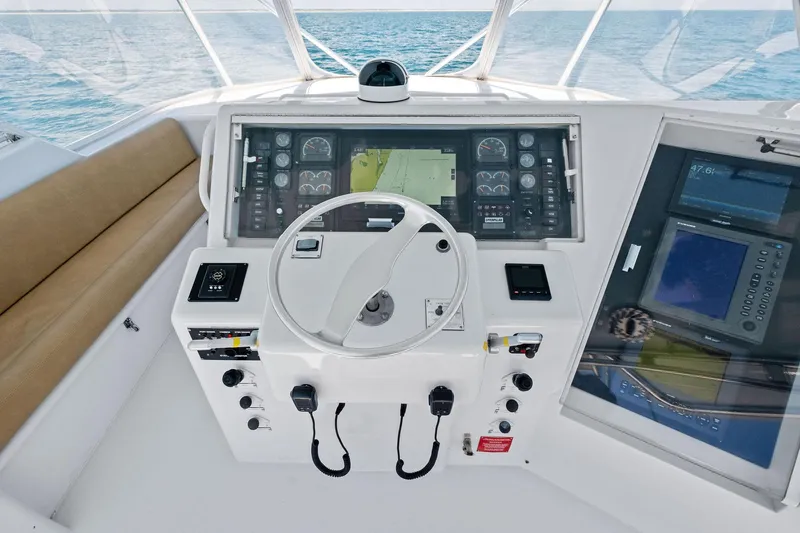 Endurance Yacht Photos Pics Helm of 1998 Hatteras 60 Convertible yacht with navigation instruments and steering wheel.