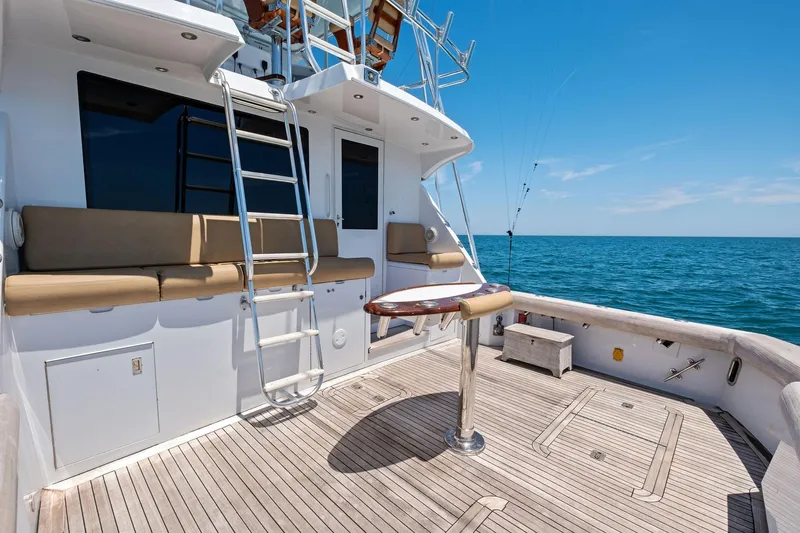 Endurance Yacht Photos Pics 1998 Hatteras 60 Convertible yacht deck with seating, ladder, and ocean view.