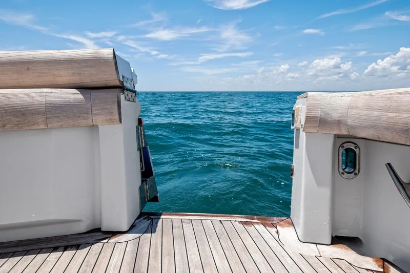 Endurance Yacht Photos Pics 1998 Hatteras 60 Convertible yacht deck overlooking the ocean under a clear blue sky.