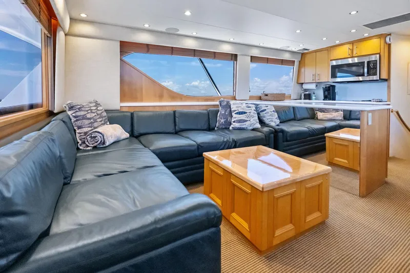 Endurance Yacht Photos Pics Luxurious interior of 1998 Hatteras 60 Convertible yacht with leather seating and modern kitchen.