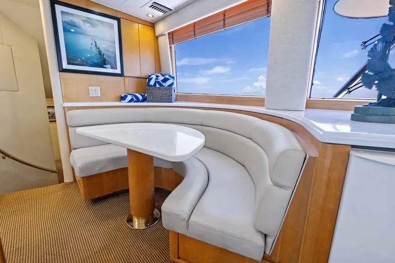 Endurance Yacht Photos Pics Interior of 1998 Hatteras 60 Convertible yacht with curved seating and table.