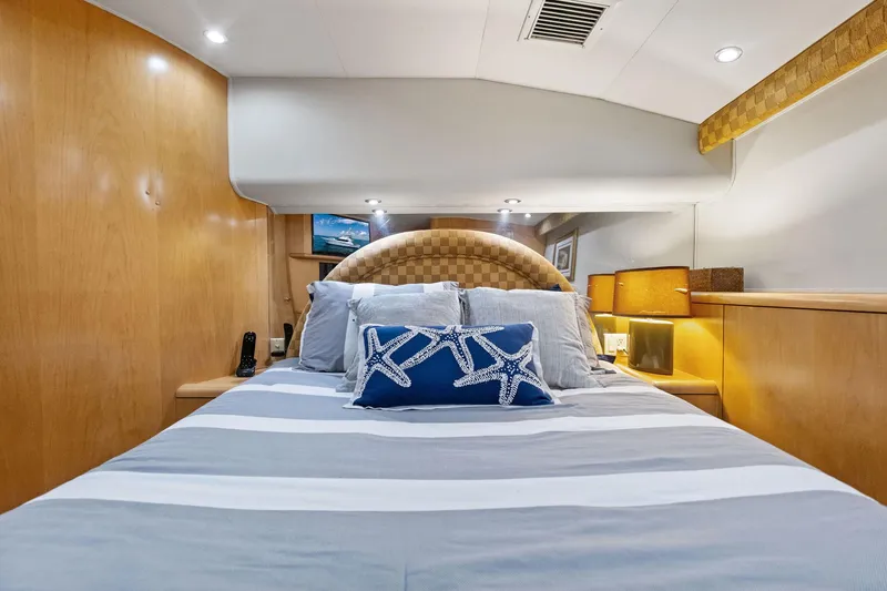 Endurance Yacht Photos Pics Luxurious cabin interior of 1998 Hatteras 60 Convertible yacht with elegant bedding.