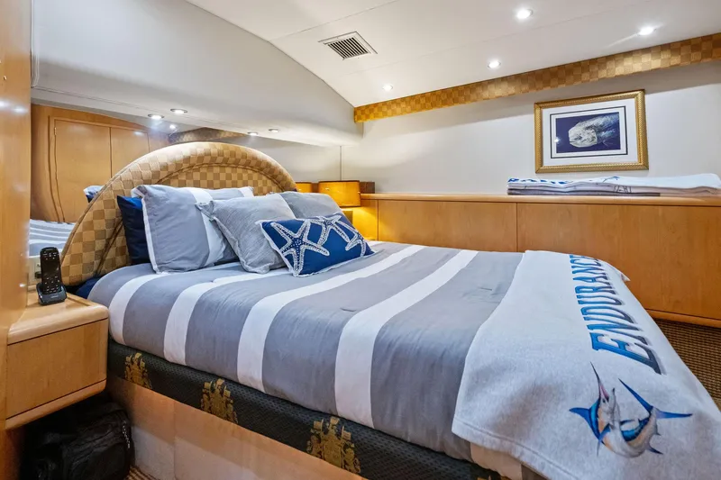 Endurance Yacht Photos Pics Luxurious bedroom interior of 1998 Hatteras 60 Convertible yacht with elegant bedding.