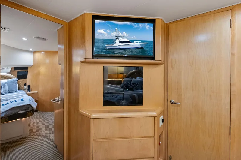Endurance Yacht Photos Pics Interior of 1998 Hatteras 60 Convertible yacht with wood paneling and TV.