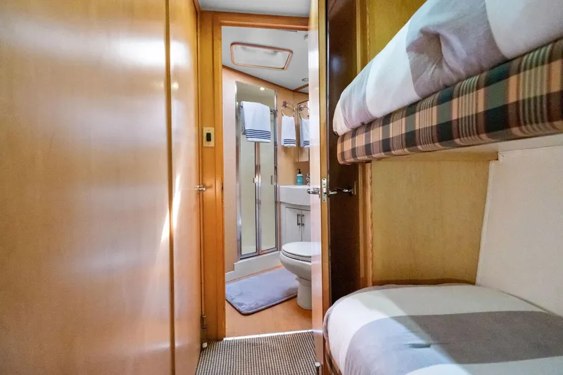 Endurance Yacht Photos Pics Interior of 1998 Hatteras 60 Convertible yacht with bunk beds and bathroom.