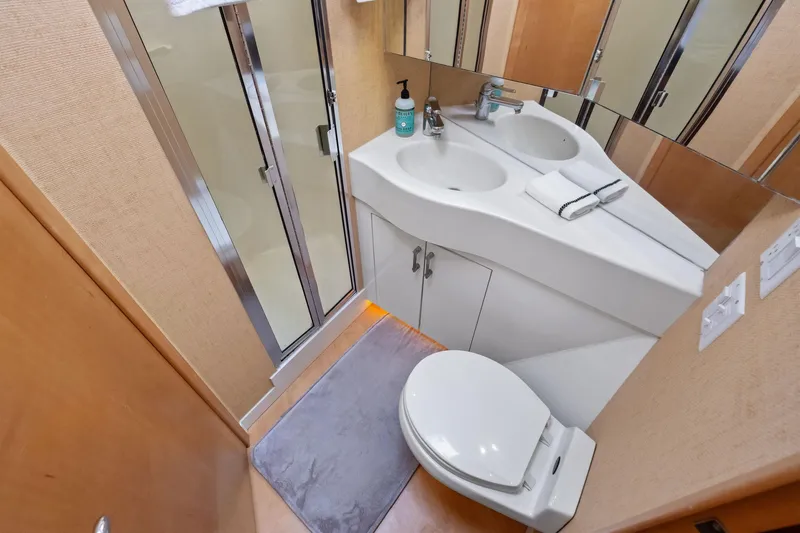 Endurance Yacht Photos Pics Bathroom interior of 1998 Hatteras 60 Convertible yacht with shower, sink, and toilet.