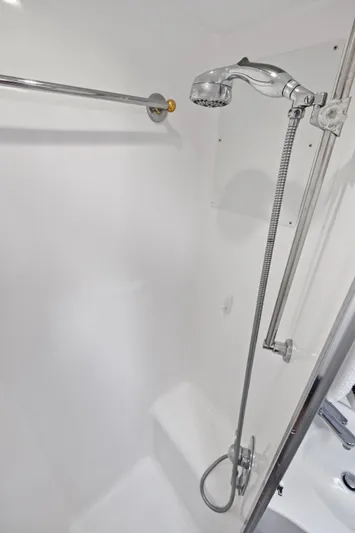 Endurance Yacht Photos Pics Shower area in 1998 Hatteras 60 Convertible yacht, featuring chrome fixtures and white interior.