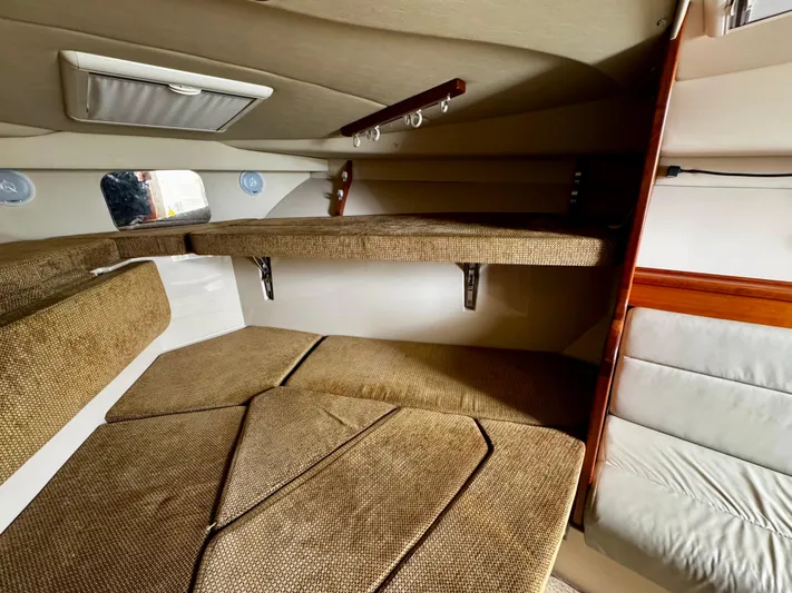 Los Gemelos Yacht Photos Pics 2006 Rampage 33 Express Barta Canyon Edition cabin with beige upholstery and wooden accents.