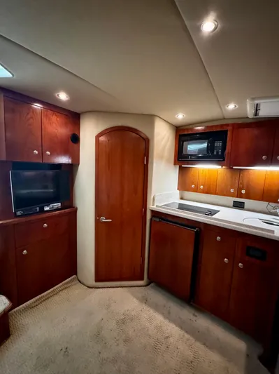 Los Gemelos Yacht Photos Pics 2006 Rampage 33 Express Barta Canyon Edition interior with wood cabinetry and modern appliances.