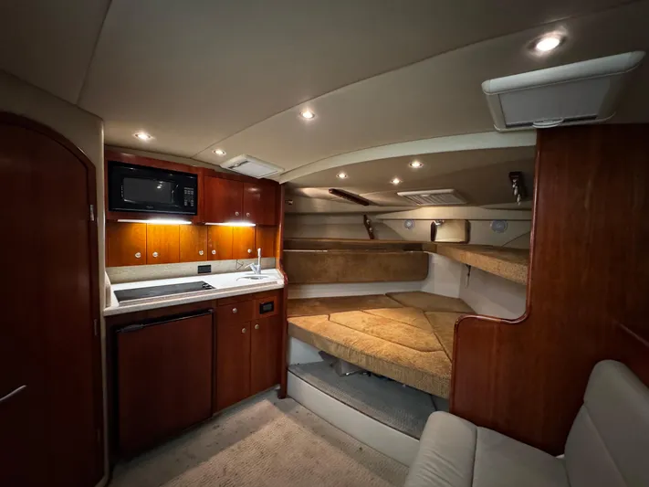 Los Gemelos Yacht Photos Pics Luxurious interior of 2006 Rampage 33 Express Barta Canyon Edition yacht with kitchenette and cozy sleeping area.