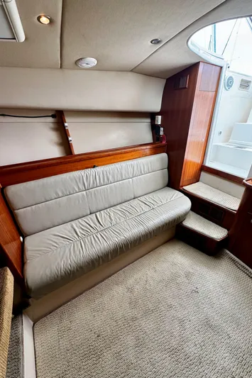 Los Gemelos Yacht Photos Pics 2006 Rampage 33 Express Barta Canyon Edition interior with beige seating and wooden accents.