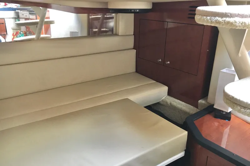 Yacht Photos Pics Interior of 2007 Sea Ray 340 Sundancer with beige seating and wooden cabinetry.