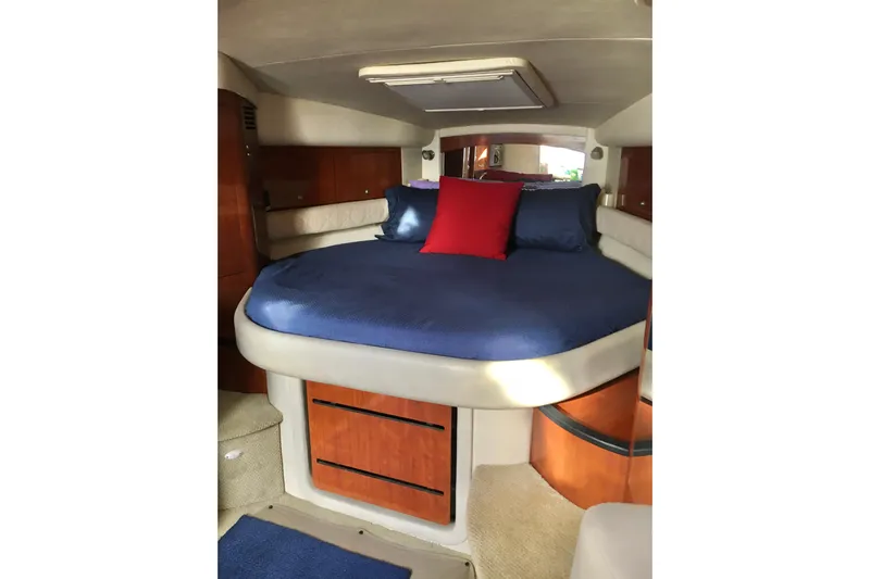  Yacht Photos Pics Luxurious cabin interior of 2007 Sea Ray 340 Sundancer with cozy bed and elegant wood finish.