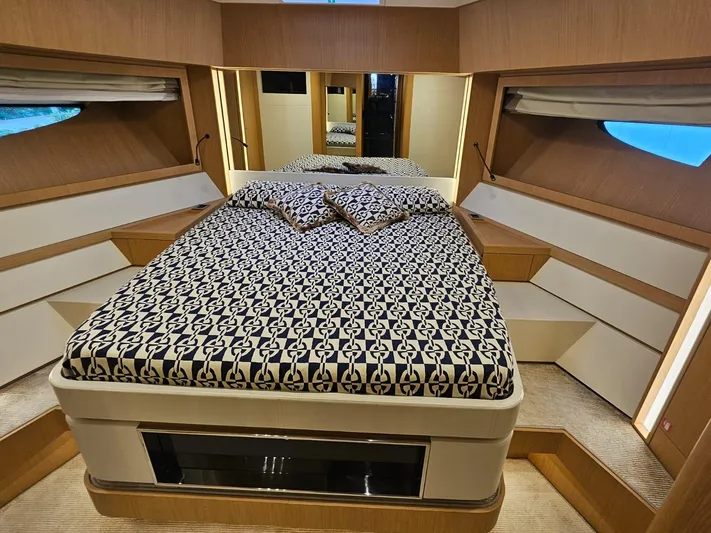  Yacht Photos Pics Luxurious bedroom interior of 2016 Riva 88' Domino Super yacht with patterned bedding.