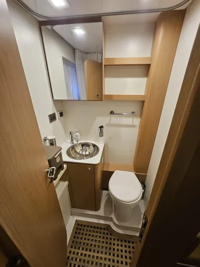  Yacht Photos Pics Luxurious bathroom in 2016 Riva 88' Domino Super yacht with modern fixtures and wooden accents.