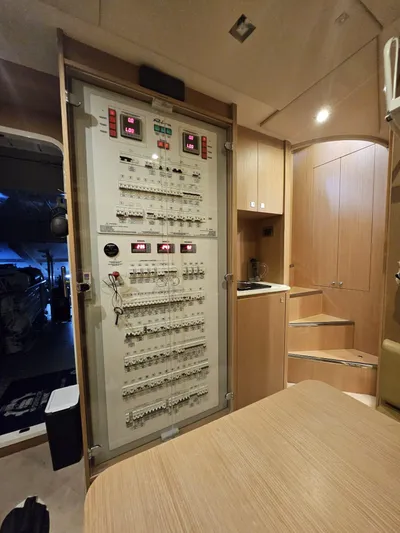  Yacht Photos Pics Electrical panel inside 2016 Riva 88' Domino Super yacht, featuring modern wooden interior design.