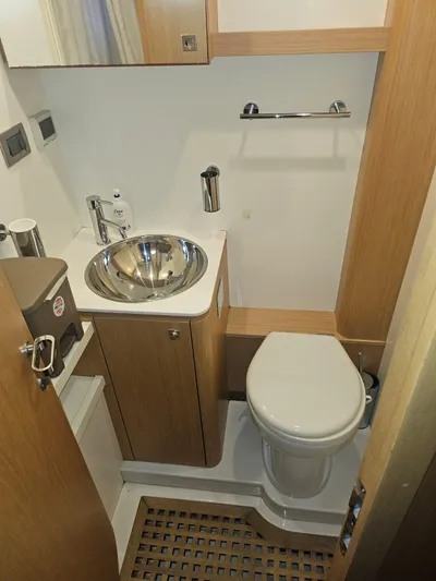  Yacht Photos Pics Compact bathroom in 2016 Riva 88' Domino Super yacht with modern fixtures and wooden accents.