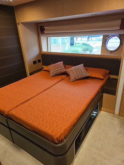  Yacht Photos Pics Luxurious bedroom interior of 2016 Riva 88' Domino Super yacht with orange bedding.