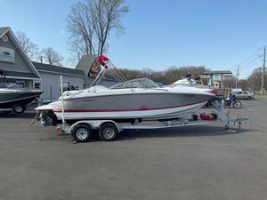2013 Cobalt 210 boat on trailer in parking lot, clear sky background.