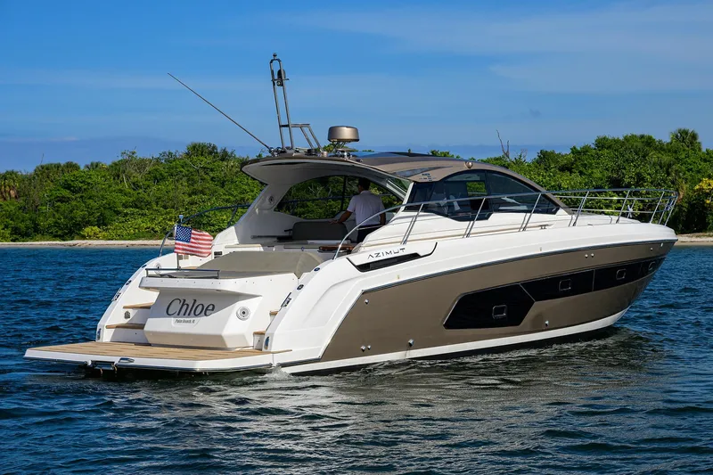 Chloe Yacht Photos Pics 2020 Azimut 45 Atlantis yacht cruising near lush green shoreline.