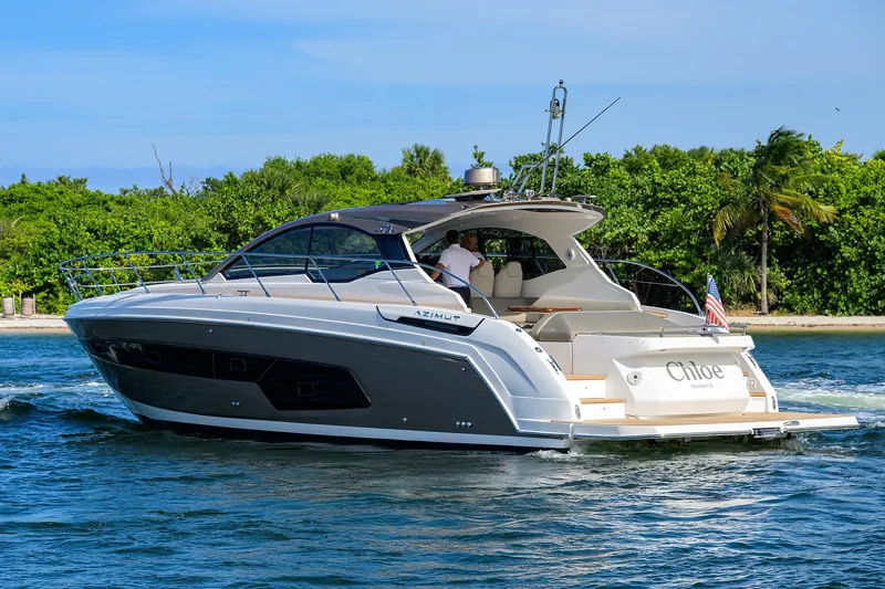 Chloe Yacht Photos Pics 2020 Azimut 45 Atlantis yacht cruising near lush tropical shoreline.