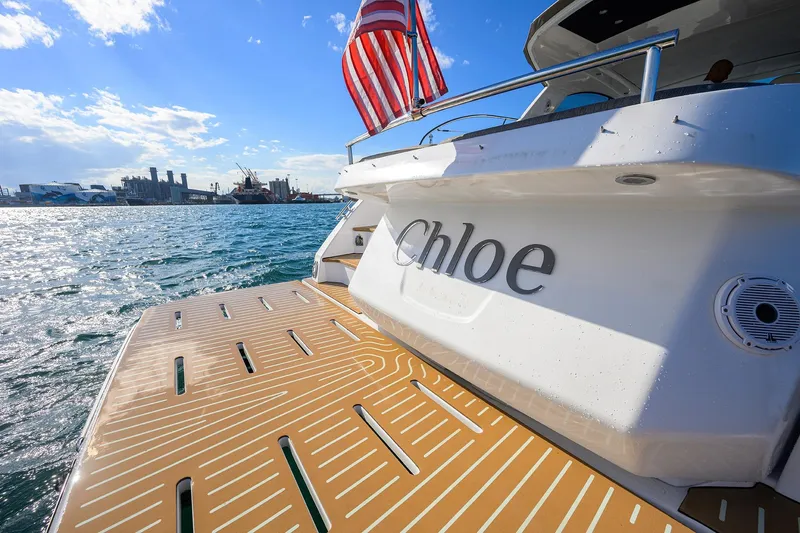 Chloe Yacht Photos Pics Azimut 45 Atlantis 2020 yacht "Chloe" with American flag on sunny waterfront.