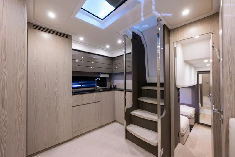 Chloe Yacht Photos Pics Luxurious interior of 2020 Azimut 45 Atlantis yacht with modern kitchen and staircase.