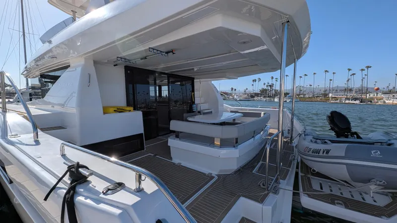 Hamlet Yacht Photos Pics 2023 Leopard Powercat yacht with spacious deck and seating, docked by the water.