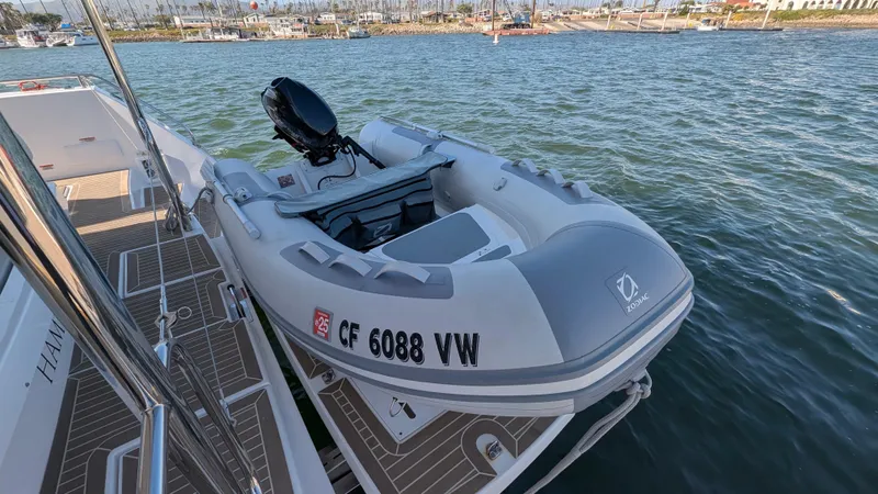 Hamlet Yacht Photos Pics 2023 Leopard Powercat with inflatable boat docked on calm water.