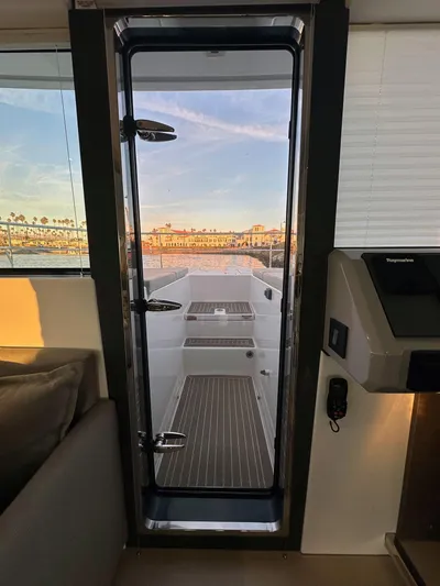 Hamlet Yacht Photos Pics 2023 Leopard Powercat yacht interior with a view through the glass door to the deck.