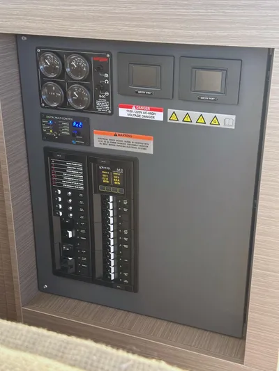 Hamlet Yacht Photos Pics Electrical control panel on a 2023 Leopard Powercat boat, featuring gauges and switches.