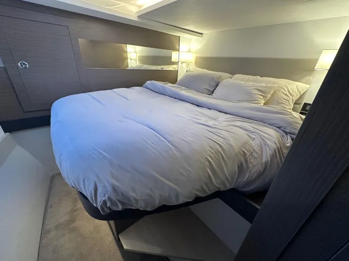 Hamlet Yacht Photos Pics Luxurious bedroom interior of 2023 Leopard Powercat yacht with cozy bedding and modern lighting.