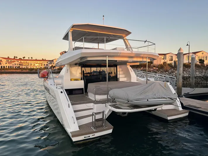 Hamlet Yacht Photos Pics 2023 Leopard Powercat yacht docked at sunset, showcasing modern design and luxury features.