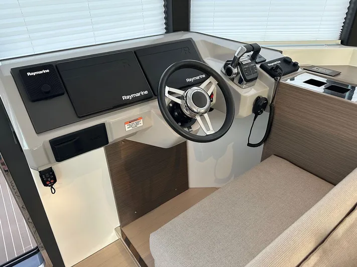 Hamlet Yacht Photos Pics 2023 Leopard Powercat helm with Raymarine electronics and modern steering wheel.