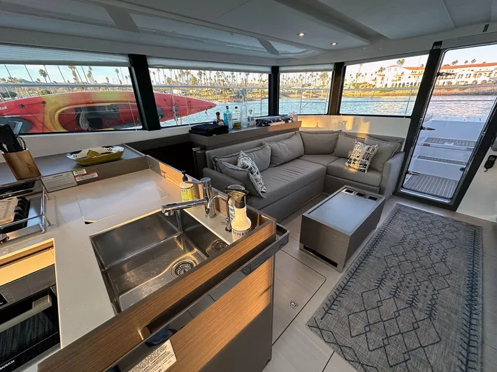 Hamlet Yacht Photos Pics Luxurious interior of 2023 Leopard Powercat yacht with modern kitchen and comfortable seating.