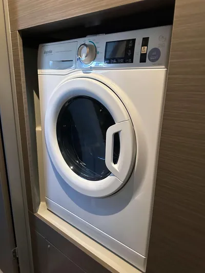 Hamlet Yacht Photos Pics 2023 Leopard Powercat washing machine in a wooden cabinet.