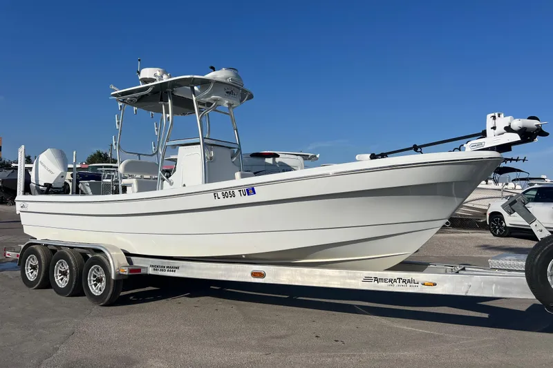  Yacht Photos Pics 2024 Andros Tarpon 26 boat on trailer, displayed outdoors under clear blue sky.