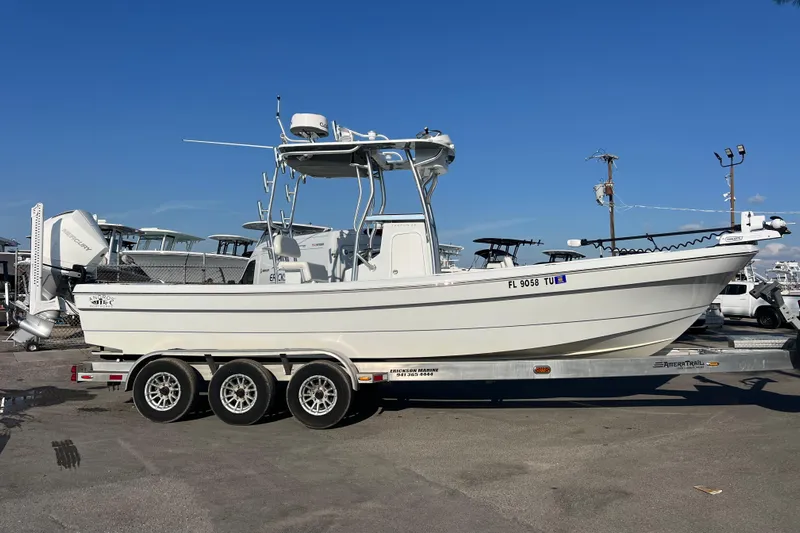  Yacht Photos Pics 2024 Andros Tarpon 26 boat on a trailer under clear blue sky.