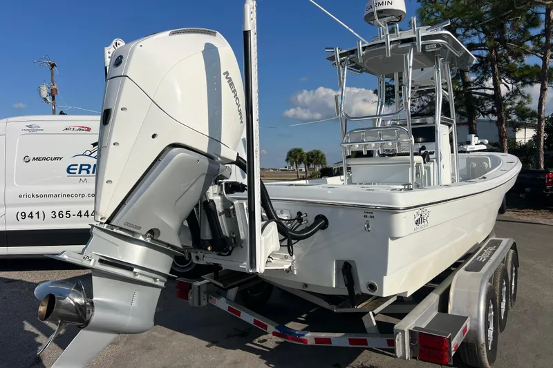  Yacht Photos Pics 2024 Andros Tarpon 26 boat on trailer with Mercury outboard engine, parked outdoors.