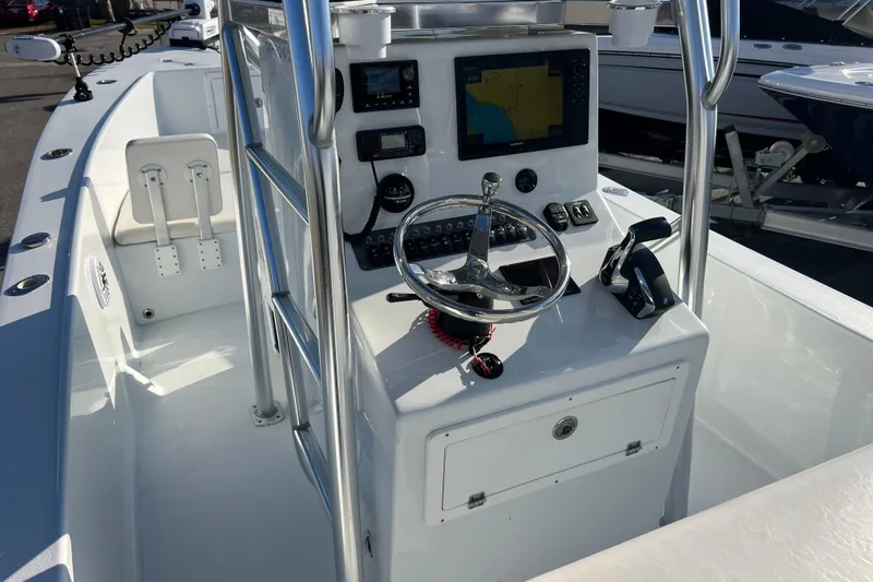 Yacht Photos Pics 2024 Andros Tarpon 26 boat console with steering wheel and navigation equipment.