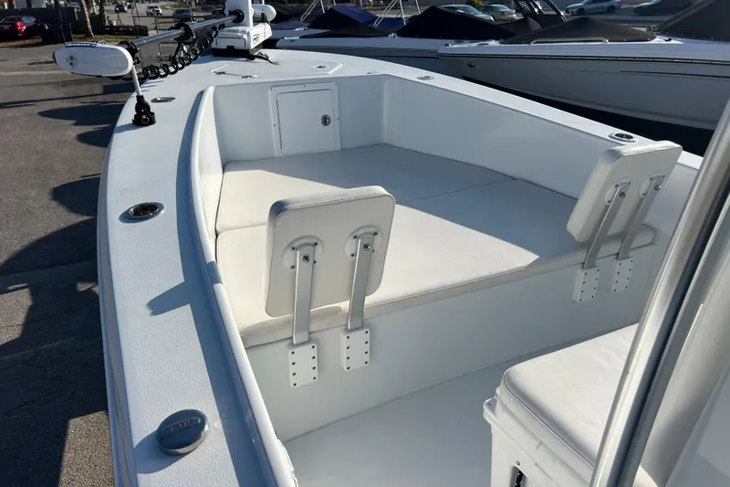  Yacht Photos Pics 2024 Andros Tarpon 26 boat interior with white seating and storage compartments.