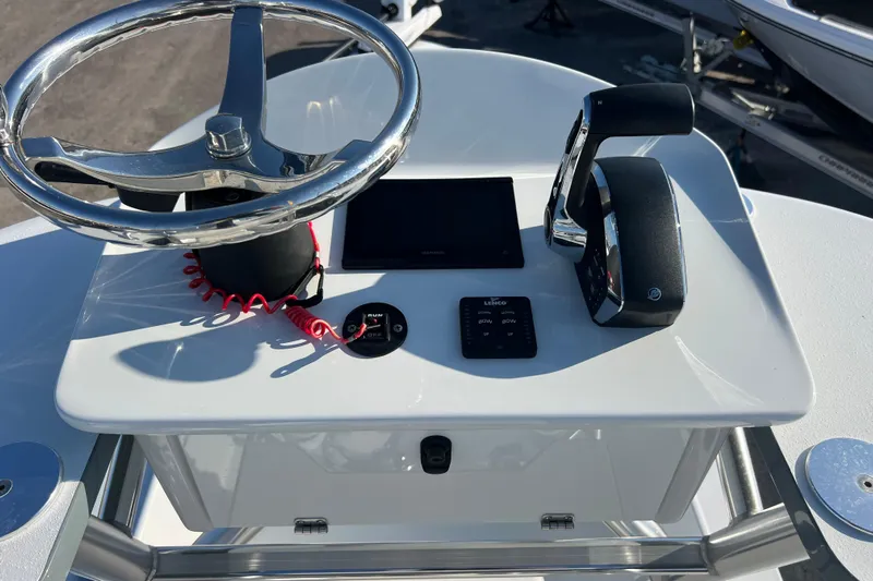  Yacht Photos Pics 2024 Andros Tarpon 26 boat console with steering wheel and controls.