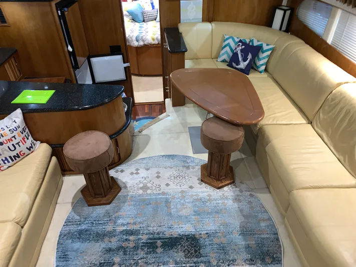 Why Knot Yacht Photos Pics Interior of 2001 Carver 396 Motor Yacht with beige seating and nautical decor.