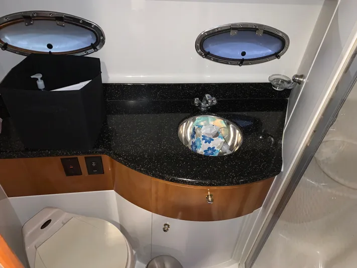 Why Knot Yacht Photos Pics 2001 Carver 396 Motor Yacht bathroom with sink, countertop, and porthole windows.