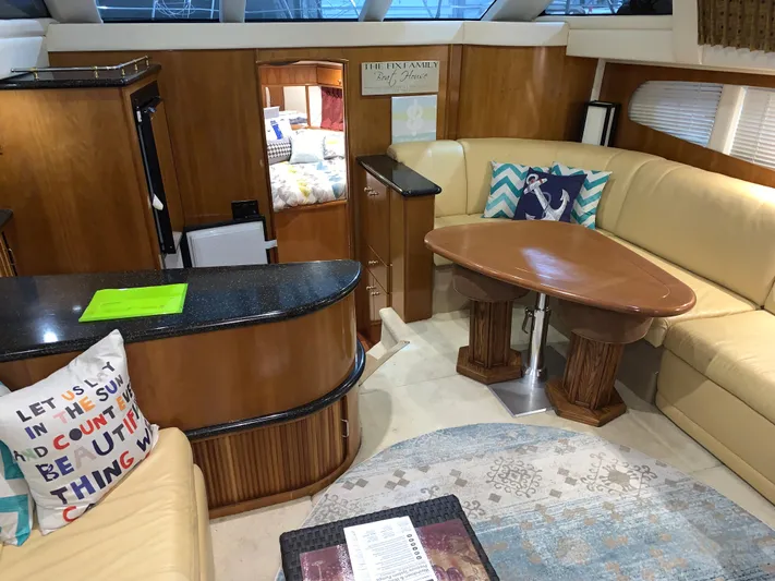 Why Knot Yacht Photos Pics Luxurious interior of 2001 Carver 396 Motor Yacht with elegant seating and wooden accents.