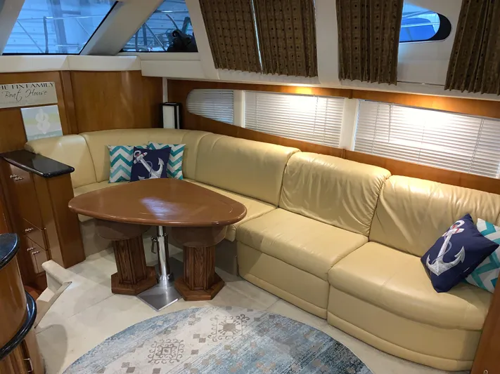 Why Knot Yacht Photos Pics Luxurious interior of 2001 Carver 396 Motor Yacht with leather seating and nautical decor.