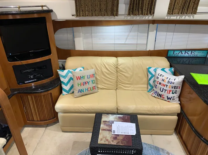 Why Knot Yacht Photos Pics Interior of 2001 Carver 396 Motor Yacht with beige sofa and decorative pillows.