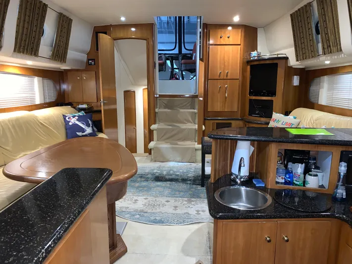 Why Knot Yacht Photos Pics Interior of 2001 Carver 396 Motor Yacht with modern kitchen and cozy seating area.