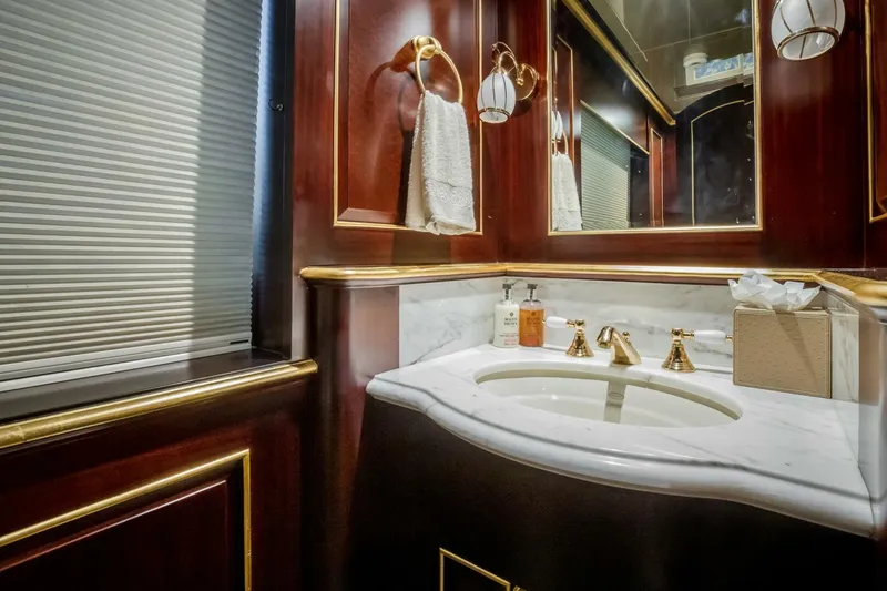Status Quo Yacht Photos Pics Luxurious yacht bathroom with marble sink, gold fixtures, and elegant wood paneling, Horizon Model Tri-Deck 2009.
