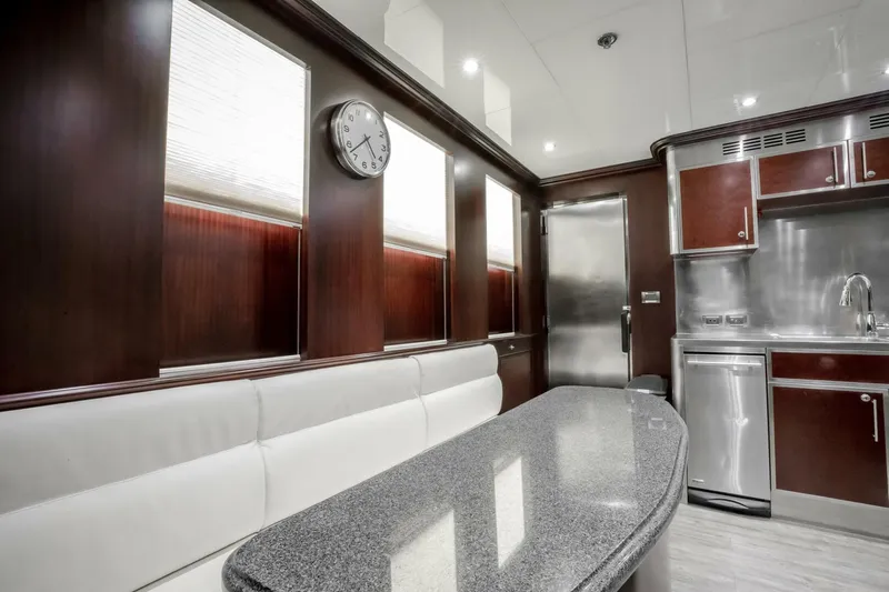 Status Quo Yacht Photos Pics Luxurious yacht interior with modern kitchen, sleek countertops, and elegant wood paneling, Horizon Model Tri-Deck 2009.